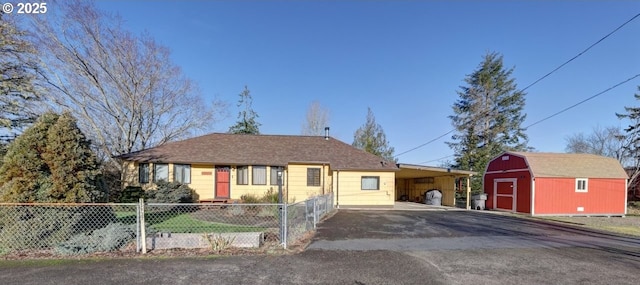 ranch-style home with a storage shed and a carport