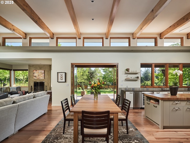 448 NW Skyline Blvd, Portland, OR 97229 - dining space featuring light wood-style floors, a large fireplace, and beamed ceiling