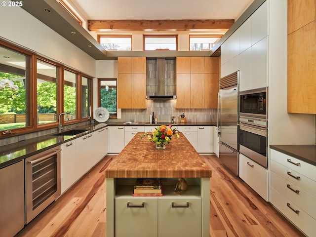 448 NW Skyline Blvd, Portland, OR 97229 - kitchen featuring black appliances, wine cooler, a sink, light wood finished floors, and beamed ceiling
