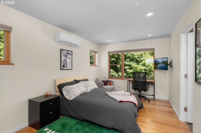 448 NW Skyline Blvd, Portland, OR 97229 - bedroom featuring an AC wall unit, wood finished floors, recessed lighting, and baseboards