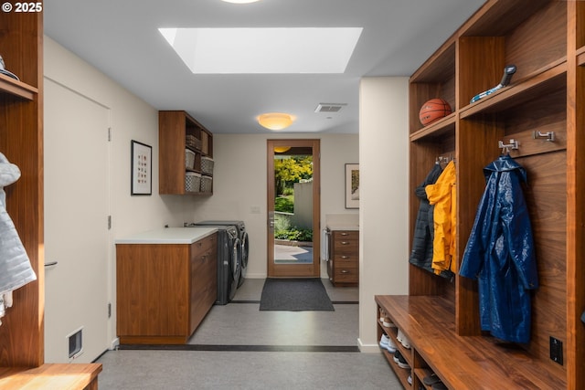 448 NW Skyline Blvd, Portland, OR 97229 - washroom featuring a skylight, separate washer and dryer, cabinet space, and baseboards