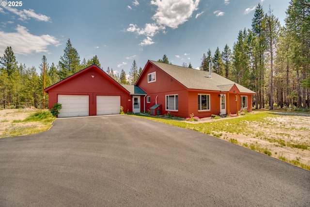 view of front of home with a front lawn and a garage