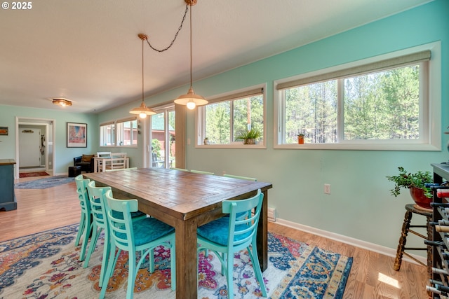 dining room featuring baseboards and light wood-type flooring