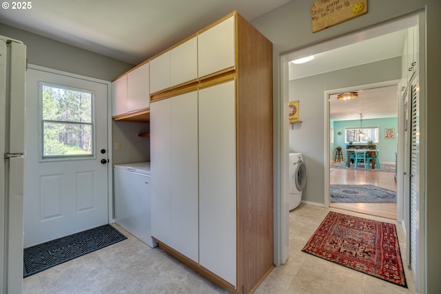 clothes washing area featuring washer / clothes dryer and laundry area