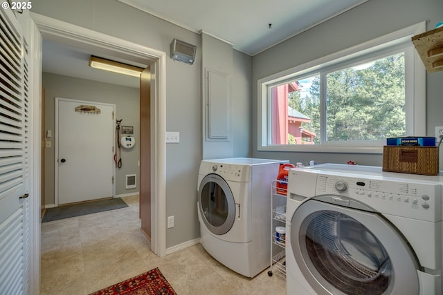 clothes washing area with visible vents, baseboards, independent washer and dryer, and laundry area