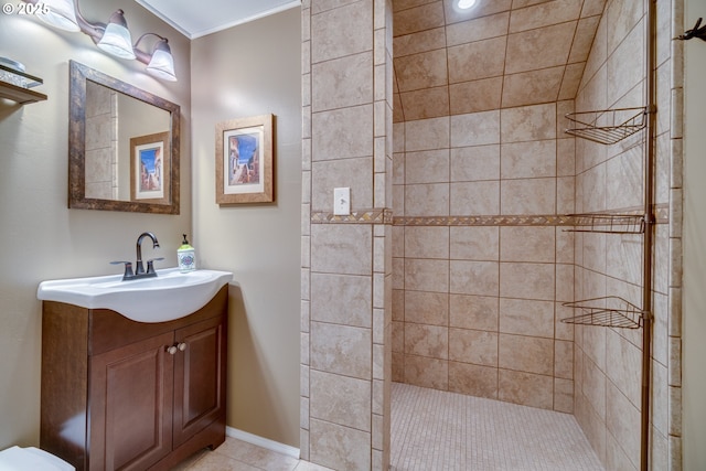 full bathroom with vanity, tile patterned floors, a tile shower, and ornamental molding