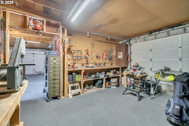 garage featuring electric panel and a workshop area