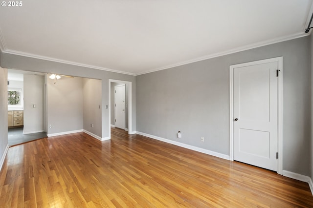 empty room featuring light hardwood / wood-style floors and ornamental molding