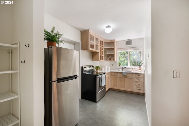 kitchen with light brown cabinets, stainless steel appliances, and sink