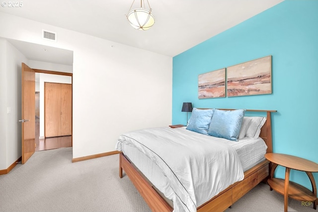 carpeted bedroom with baseboards and visible vents