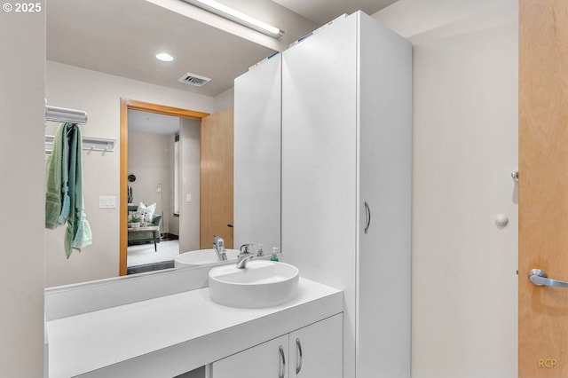 bathroom featuring recessed lighting, visible vents, and vanity