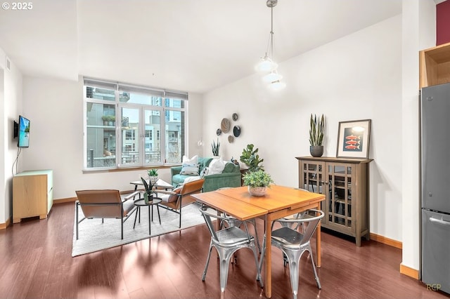 dining area with wood finished floors and baseboards