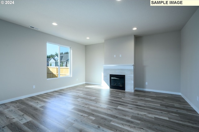 18615 NE 41st Pl Lot 288, Vancouver, WA 98686 - unfurnished living room with recessed lighting, wood finished floors, a tile fireplace, baseboards, and visible vents