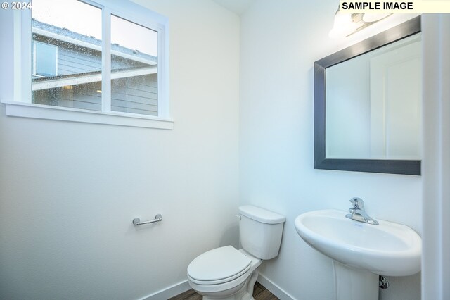 18615 NE 41st Pl Lot 288, Vancouver, WA 98686 - bathroom featuring wood finished floors, toilet, baseboards, and a sink