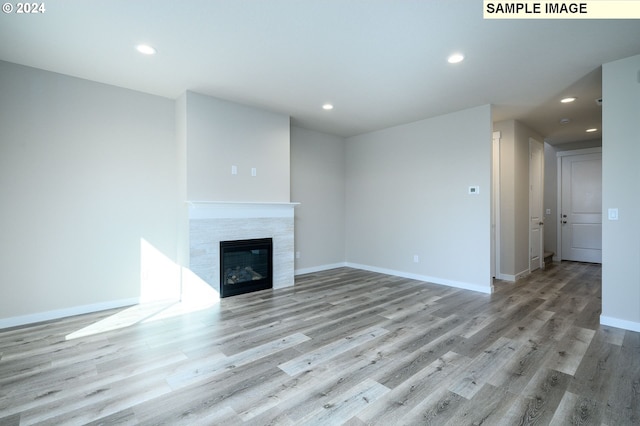 18615 NE 41st Pl Lot 288, Vancouver, WA 98686 - unfurnished living room with recessed lighting, a tiled fireplace, wood finished floors, and baseboards