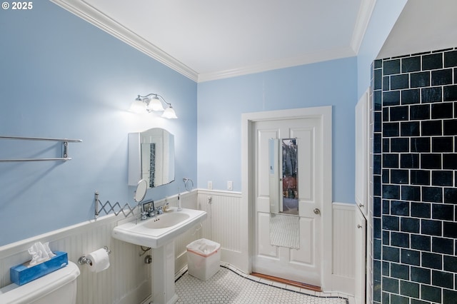 895 Pine Forest Dr, Eugene, OR 97405 - bathroom with tile patterned flooring, a wainscoted wall, ornamental molding, toilet, and a sink