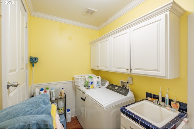895 Pine Forest Dr, Eugene, OR 97405 - laundry room featuring cabinet space, washer and clothes dryer, ornamental molding, wainscoting, and wood finished floors