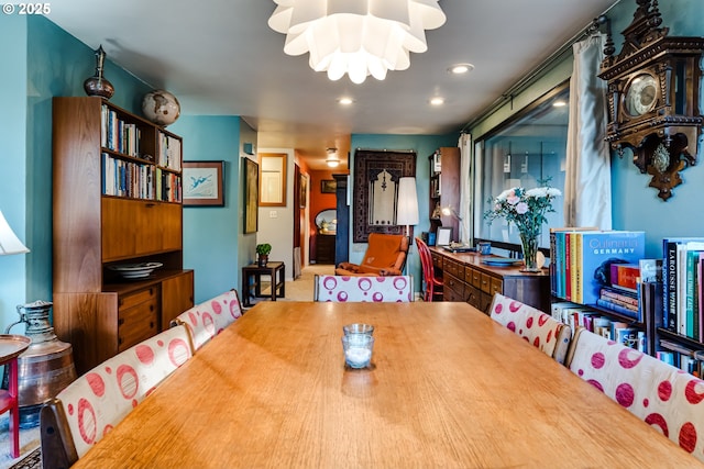 dining area with an inviting chandelier