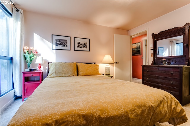 carpeted bedroom featuring multiple windows