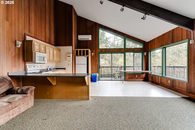 kitchen with high vaulted ceiling, a kitchen breakfast bar, wooden walls, kitchen peninsula, and white appliances