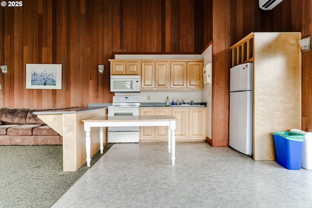 kitchen featuring an AC wall unit, wooden walls, sink, light brown cabinets, and white appliances