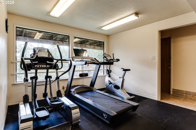 exercise room with a textured ceiling