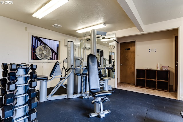 exercise room featuring a textured ceiling