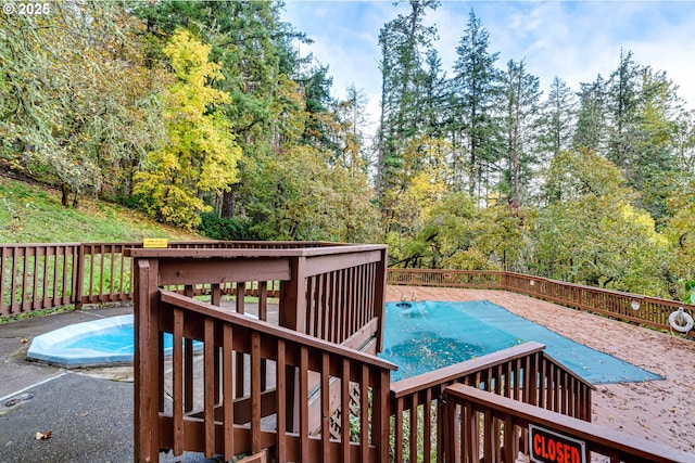 view of pool with a wooden deck