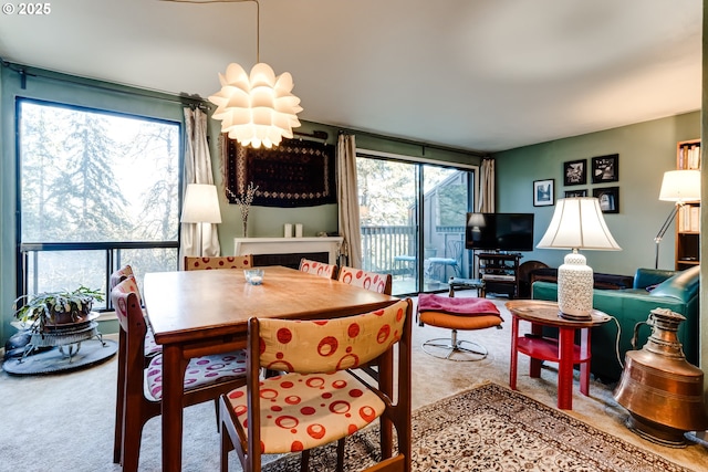 carpeted dining space featuring a chandelier