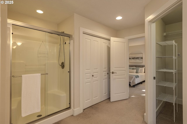 bathroom with recessed lighting, a closet, and a shower stall