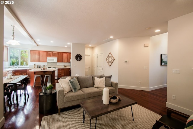 living room featuring baseboards, recessed lighting, and dark wood-style floors
