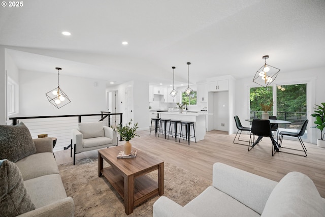 3250 SW Binford Lake Pkwy, Gresham, OR 97080 - living room with lofted ceiling, light wood finished floors, a chandelier, and recessed lighting