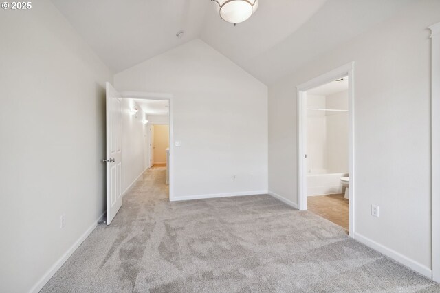 7612 NE 34th Ave Unit A8, Vancouver, WA 98665 - unfurnished bedroom with lofted ceiling, baseboards, carpet flooring, and connected bathroom