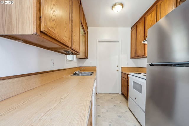 kitchen with sink, white electric range, and stainless steel refrigerator