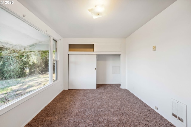 unfurnished bedroom with carpet floors and a closet