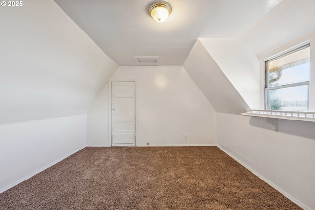 bonus room featuring lofted ceiling and carpet flooring