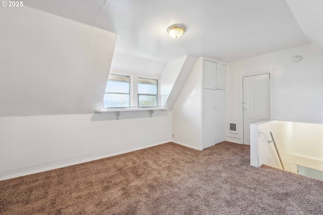 bonus room featuring lofted ceiling and carpet