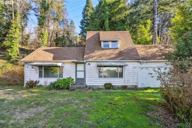 view of front of property with a garage and a front yard