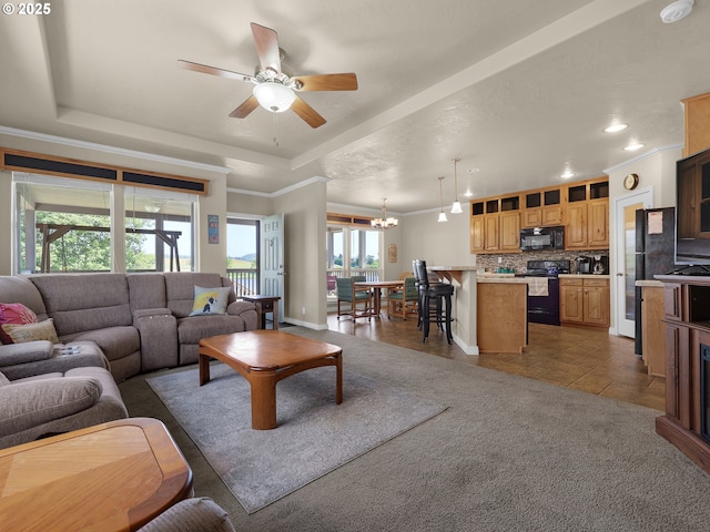 90637 Lewis Rd, Warrenton, OR 97146 - living room featuring a raised ceiling, a ceiling fan, a chandelier, recessed lighting, and crown molding