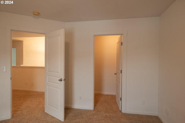 interior space featuring light colored carpet