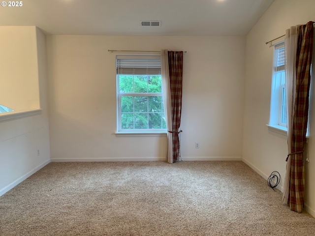 carpeted spare room with vaulted ceiling