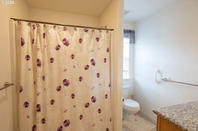 bathroom featuring toilet, vanity, and curtained shower