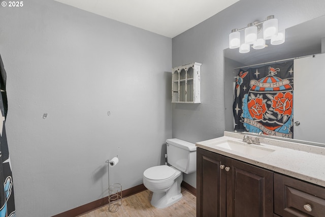 bathroom featuring hardwood / wood-style flooring, vanity, and toilet