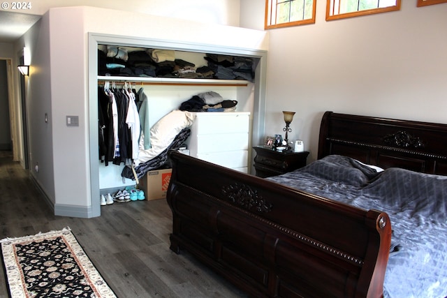 bedroom featuring a closet, baseboards, and wood finished floors