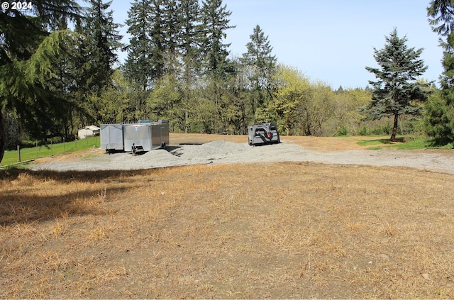 view of yard with a view of trees