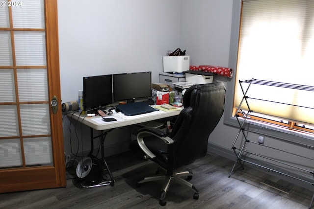 office space with wood finished floors and visible vents