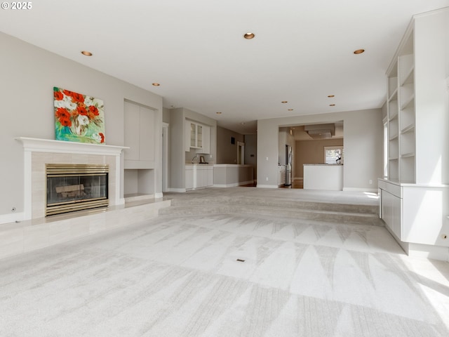 6903 SE Riverside Dr Unit 20, Vancouver, WA 98664 - unfurnished living room featuring light colored carpet, a tile fireplace, recessed lighting, and baseboards