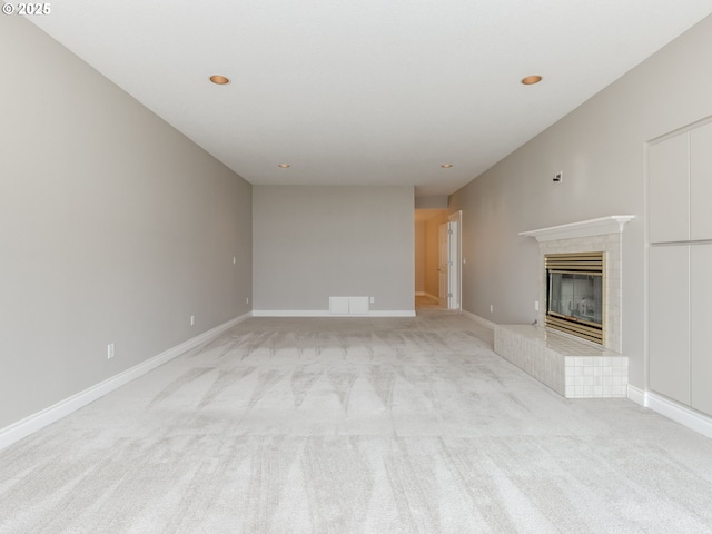 6903 SE Riverside Dr Unit 20, Vancouver, WA 98664 - unfurnished living room featuring light carpet, a tiled fireplace, recessed lighting, and baseboards