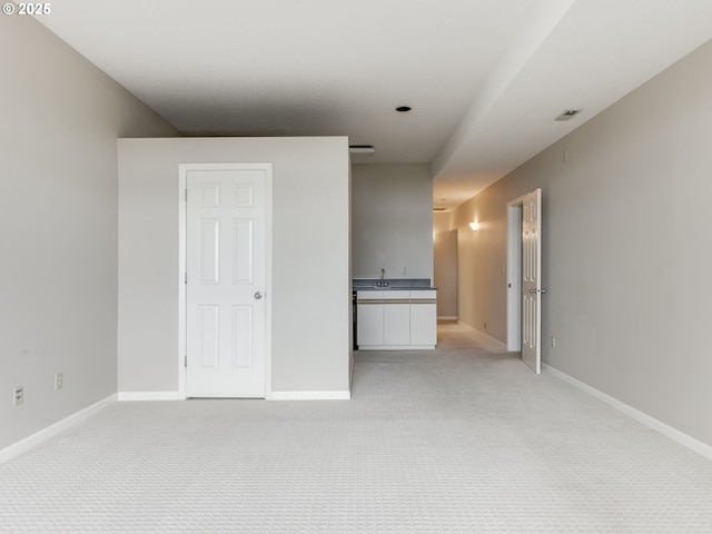 6903 SE Riverside Dr Unit 20, Vancouver, WA 98664 - spare room with light colored carpet, a sink, and baseboards