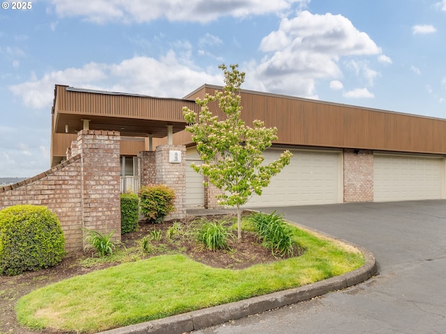 6903 SE Riverside Dr Unit 20, Vancouver, WA 98664 - view of front of property featuring driveway, brick siding, and a garage